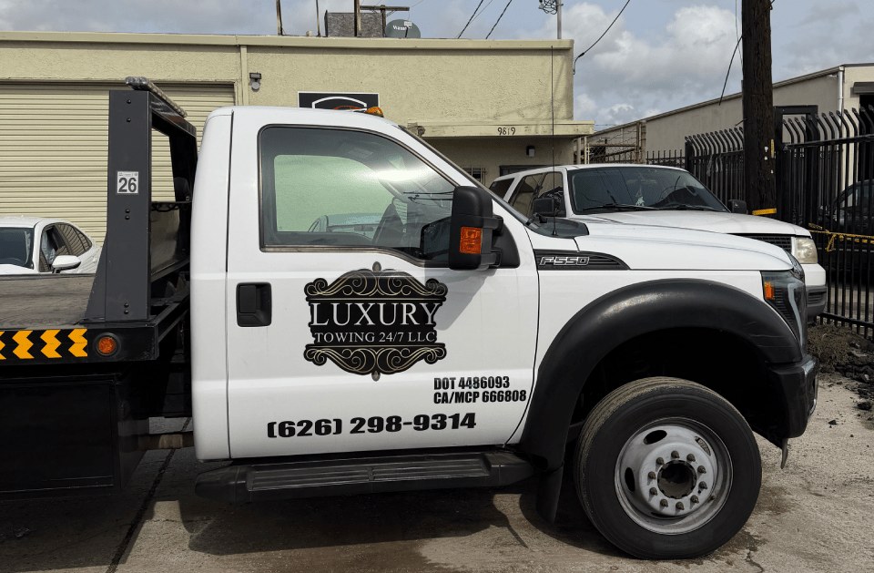 Side of RJ’s Luxury Towing flatbed truck